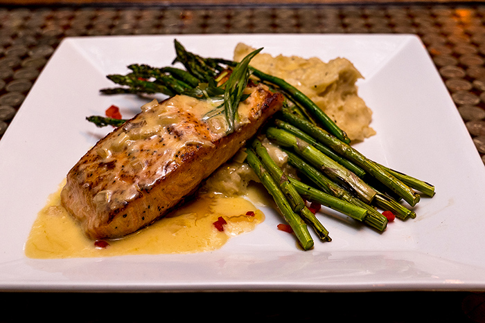 2 Entrées: Choose between an 8 oz. sirloin with peppercorn sauce or salmon fillet with beurre blanc. Each entrée served with house-made parmesan risotto and sautéed green beans